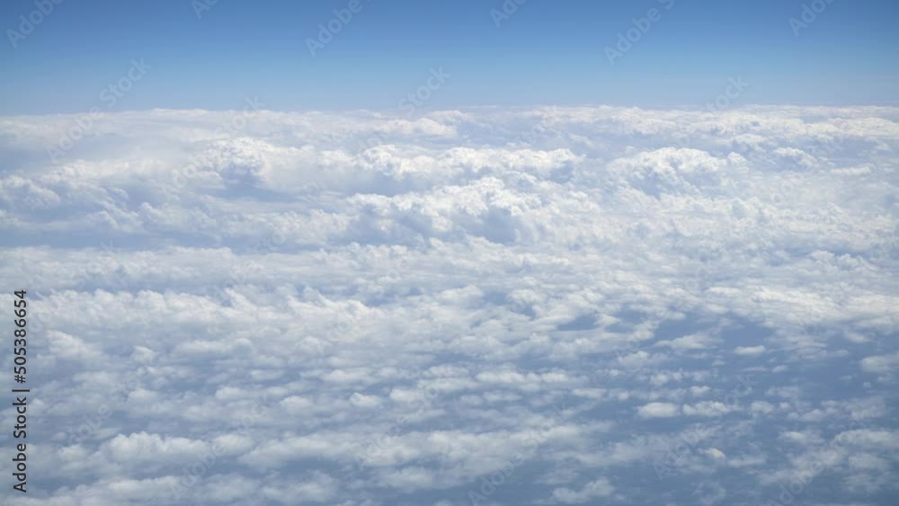 Wonderful view of cloudscape with clear blue sky from above. Beautiful panorama above white clouds as seen through window of an aircraft. A view from airplane. Wonderful view of cloudscape with clear blue sky from above. Beautiful panorama above white clouds as seen through window of an aircraft. A view from airplane.
