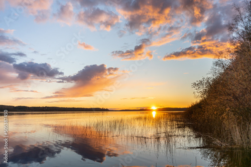 Wooden pier at a large lake during sunset