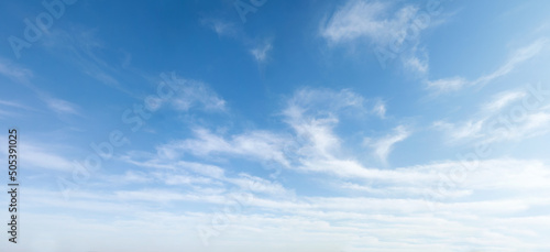 Wide angle photo of sunny and windy weather sky with blue tones. Summer or spring sky with cloudscape. photo