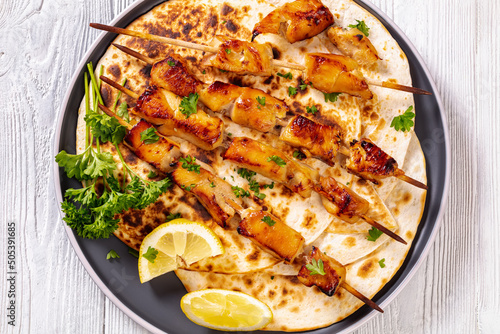 grilled chicken skewers with flatbreads  top view