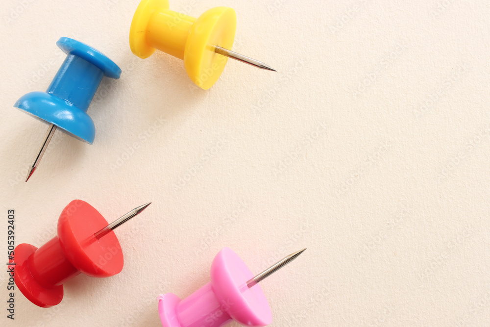 Close up image of push pins over pastel background Close up image of push pins over pastel background