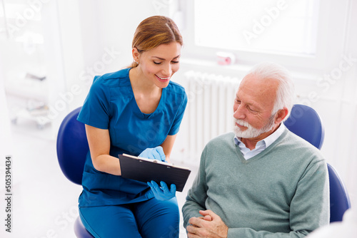 Obraz na plátne Doctor explaining medical procedure consent form to patient
