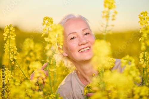 Portrait of a middle-aged woman in the rapeseed chain.