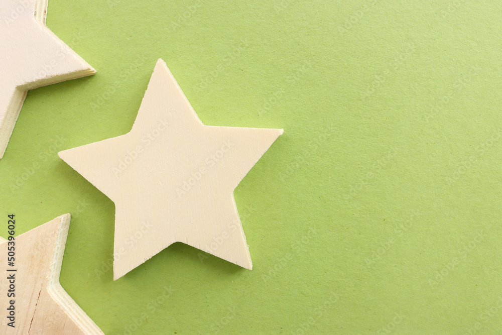 Top view image of wooden star over textured green background Top view image of wooden star over textured green background