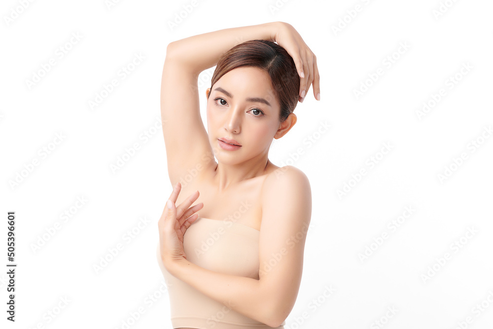 Obraz premium Beautiful Young Asian woman lifting hands up to show off clean and hygienic armpits or underarms on white background, Smooth armpit cleanliness and protection concept