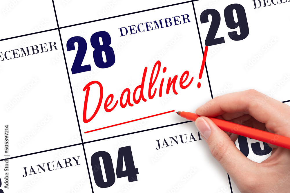 Hand drawing red line and writing the text Deadline on calendar date December 28. Deadline word written on calendar Hand drawing red line and writing the text Deadline on calendar date December 28. Deadline word written on calendar
