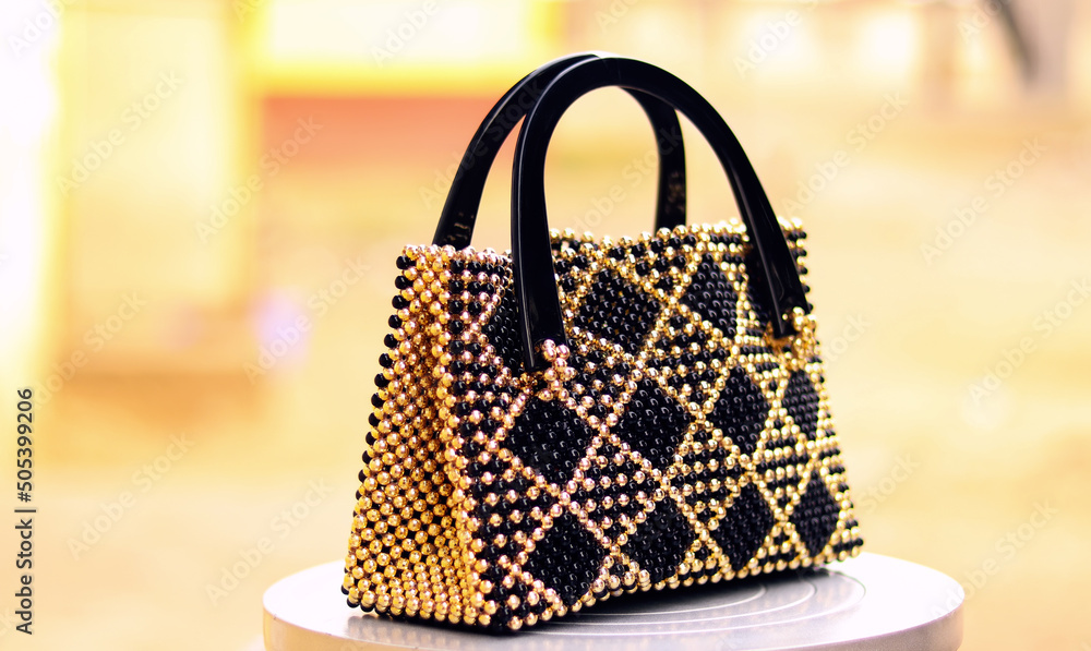 Isolated Beaded bag with gold and black colors. Bead bag. bead making and bead works Stock Foto Adobe Stock
