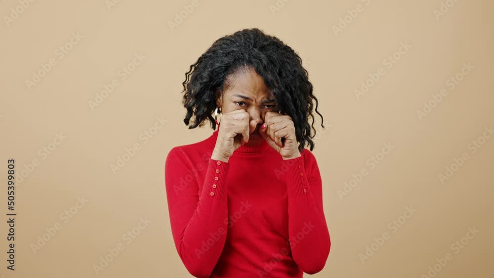 Female caprices and hysterics. Studio portrait of young upset african american lady wearing red sweater crying to camera Female caprices and hysterics. Studio portrait of young upset african american lady wearing red sweater crying to camera