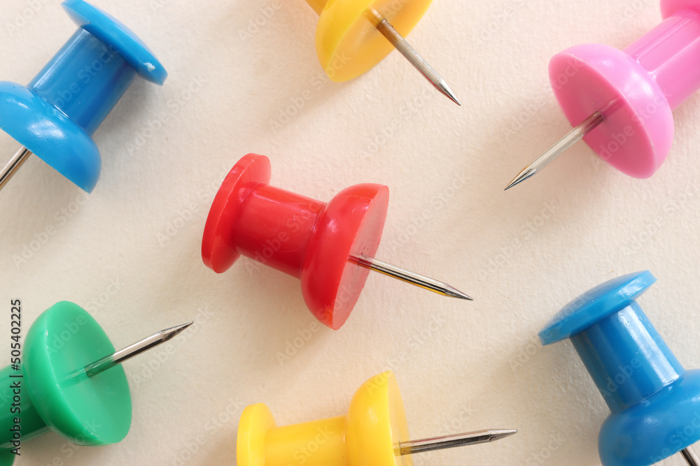 Close up image of push pins over pastel background Close up image of push pins over pastel background