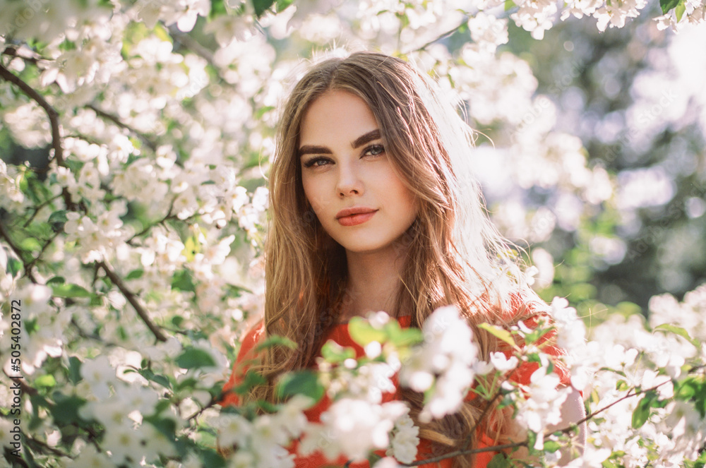 Beautiful young woman in summer garden. Beauty summertime. Film photography Beautiful young woman in summer garden. Beauty summertime. Film photography
