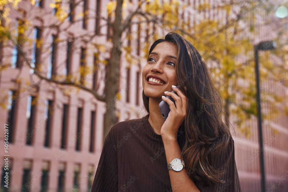 Happy businesswoman talking on phone on street Happy businesswoman talking on phone on street