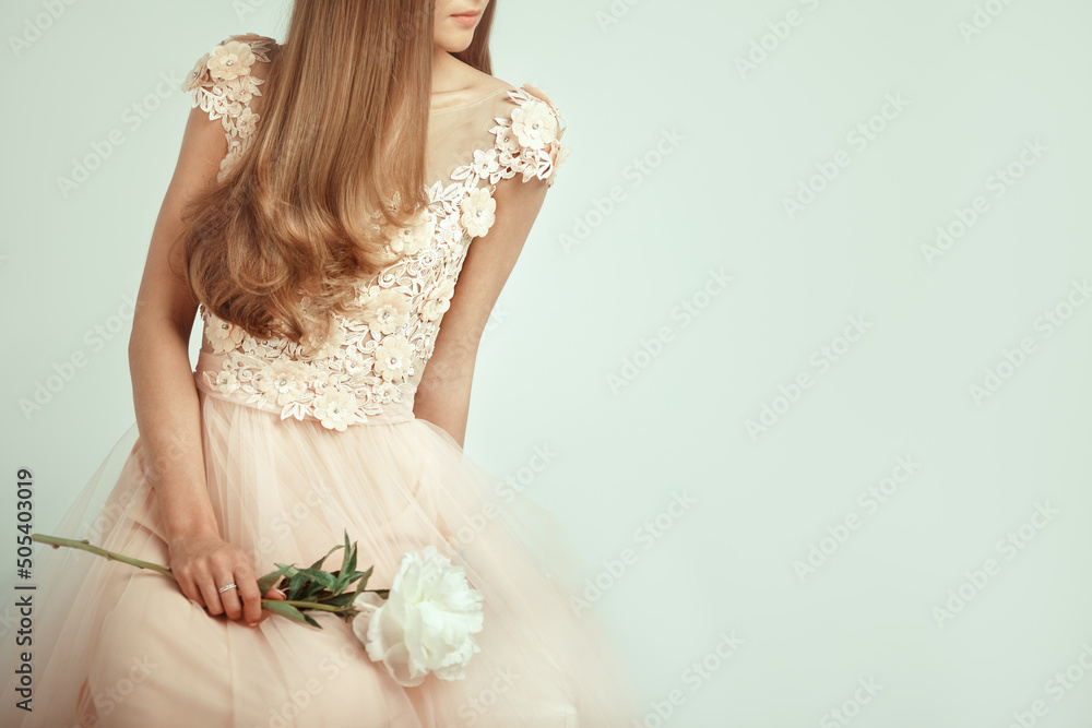 Beautiful Woman in Lace Wedding Dress. Beautiful Lady with Healthy and Beauty Hair. Woman with a peony