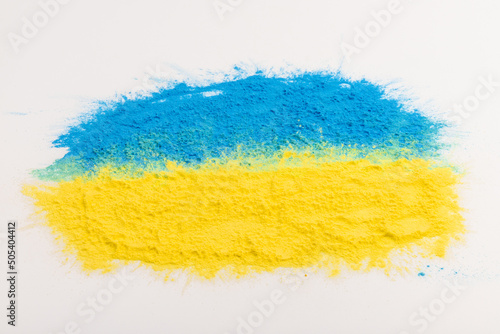 colorful Ukrainan flag yellow blue color holi paint powder explosion isolated on white background. russia ukraine conflict war freedom concept photo