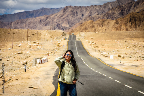 Young Indian woman solo traveller enjoying the beautiful landscape of Ladakh photo