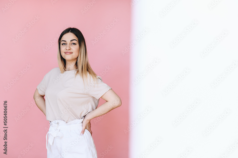 Half of the photo is white, on the other half is a girl and hands at her sides on a pink background Half of the photo is white, on the other half is a girl and hands at her sides on a pink background