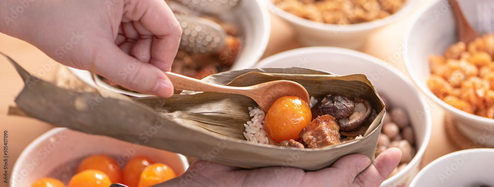 Making zongzi food - preparing and wrapping Chinese rice dumpling. Making zongzi food - preparing and wrapping Chinese rice dumpling.