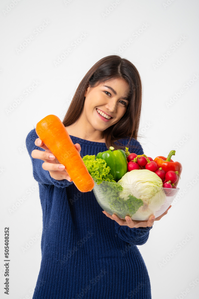 Portrait of beautiful smiling asian woman holding bowl full of fresh organic vegetables isolated on white background, concept of healthy food nutrition, Concept of healthy food nutrition, vegetarian Portrait of beautiful smiling asian woman holding bowl full of fresh organic vegetables isolated on white background, concept of healthy food nutrition, Concept of healthy food nutrition, vegetarian