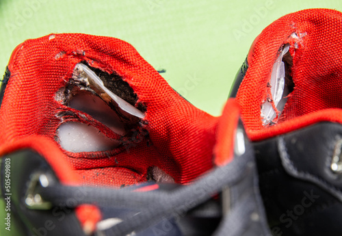 Fotografija Old worn out ripped sneakers