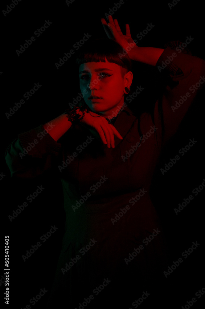 A gothic girl in smoke with dark background and neon light