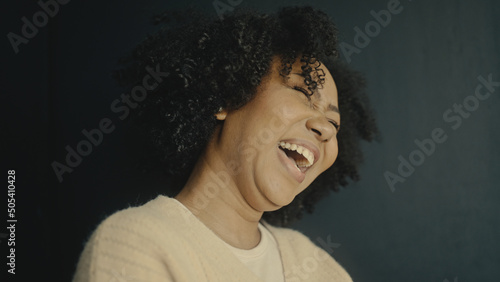 black woman laugh and jump happy.