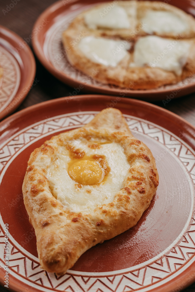 Adjarian khachapuri on the table with egg yolk. view from above