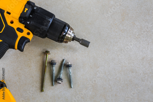 Cordless Hammer Drill/Driver with screw on Cement board background