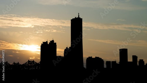 Yeouido, Yeongdeungpo-gu; Time Lapse at Sunrise with highrise buildings of financial district in Silhouette, Seoul, South Korea photo