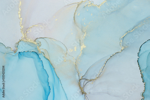 Abstract alcohol ink background in blue azure tones with golden splashes