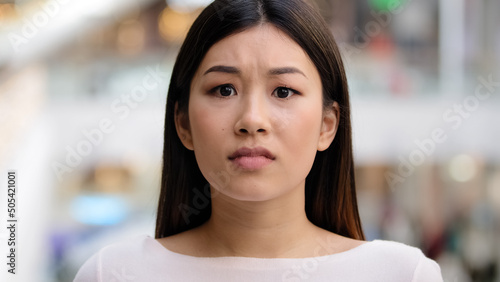 Close up female emotional face asiang girl shocked stressful woman model frightened lady scared horror disgust shock afraid unpleasant bad news unexpected surprise bankruptcy crisis war lose reaction