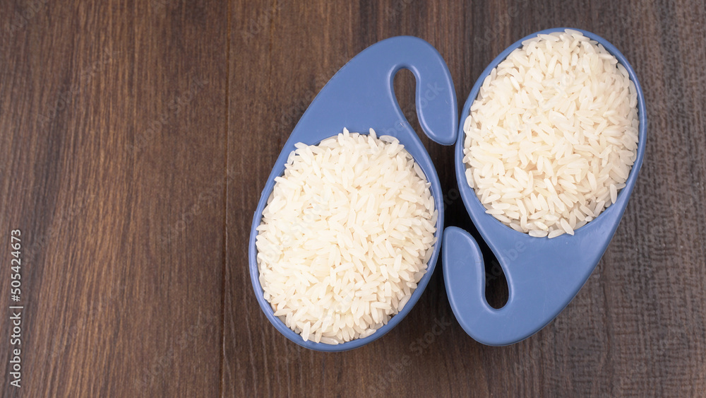 Uncooked dry rice in wooden bowl, Healthy food. Copy space. Uncooked dry rice in wooden bowl, Healthy food. Copy space.