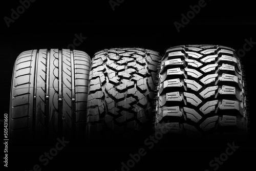 mud all-season all terrain tires and road wheel on a black background. photo