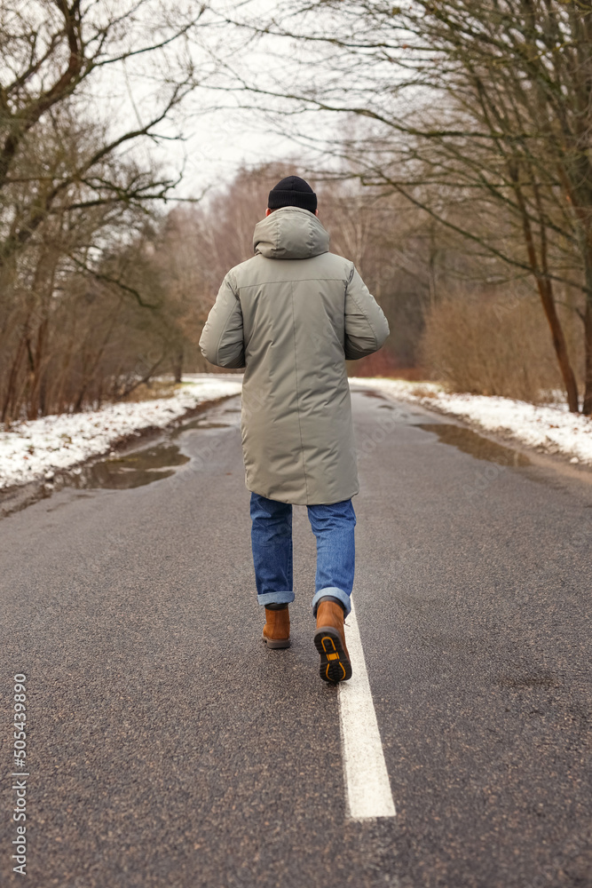Photo of a person walking on the road Photo of a person walking on the road