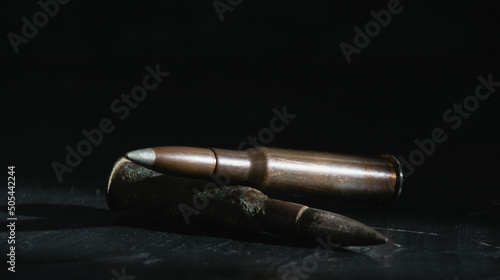 Ammunition on a dark background close-up, banner format. The concept of modern armaments and war in Ukraine