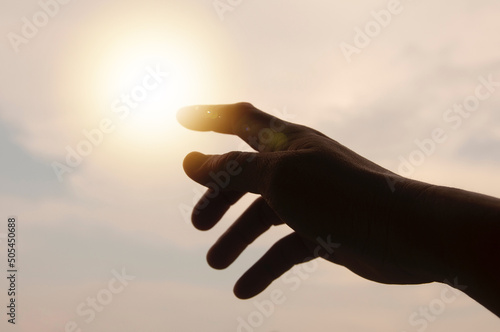 Hands reaching out to bright sky. Reaching out concept
