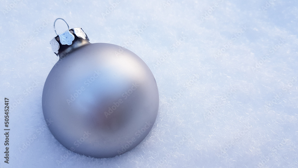 A Christmas tree toy in the form of a ball in shades very characteristic of the fashionable new year 2022. pantone color A Christmas tree toy in the form of a ball in shades very characteristic of the fashionable new year 2022. pantone color