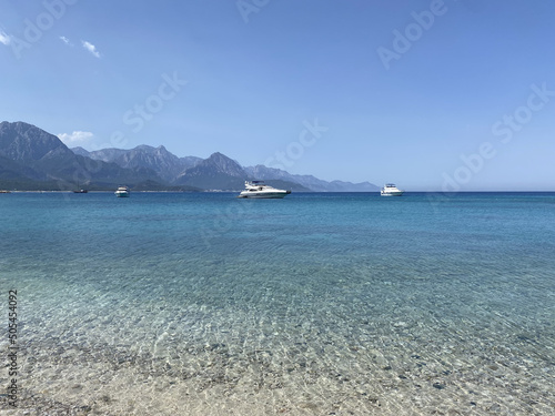 Yacht on the shore of the cozy bay, near Antalya and Kemer, Turkey on the Mediterranean coast. Beach and tourist destination. Picturesque Mediterranean seascape in Turkey. 