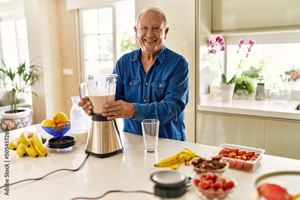 Senior man smiling confident holding jar of smoothie at kitchen Senior man smiling confident holding jar of smoothie at kitchen