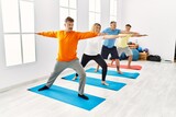 Group of middle age people concentrate  training yoga at sport center.