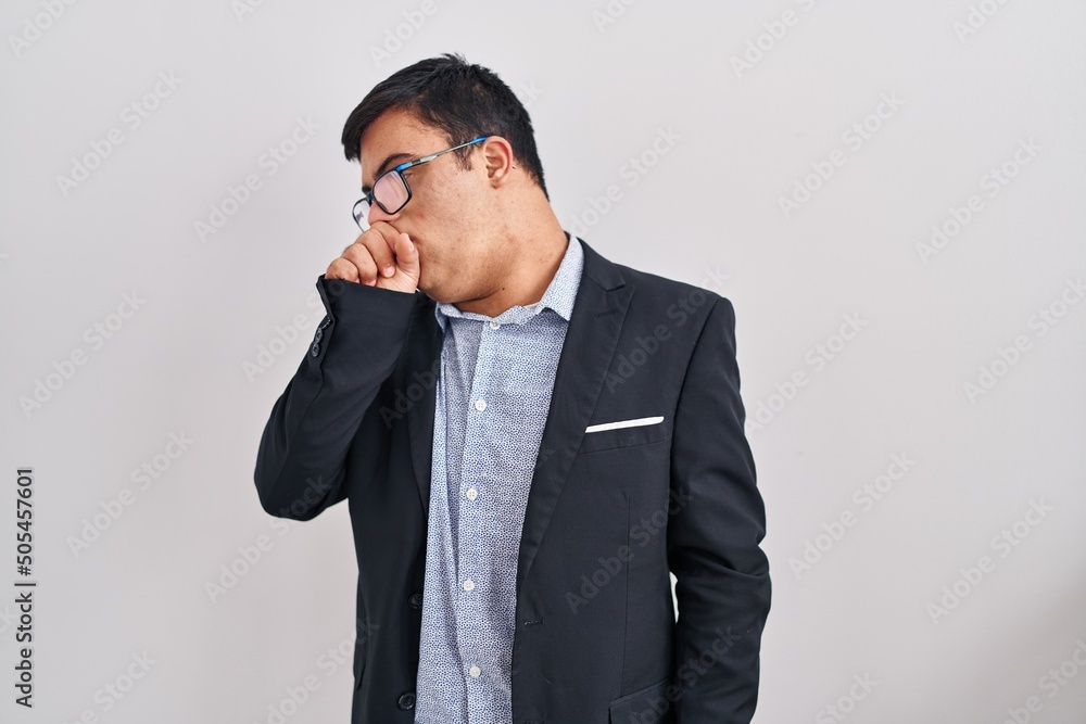 Young hispanic man with down syndrome wearing business style feeling unwell and coughing as symptom for cold or bronchitis. health care concept. Young hispanic man with down syndrome wearing business style feeling unwell and coughing as symptom for cold or bronchitis. health care concept.