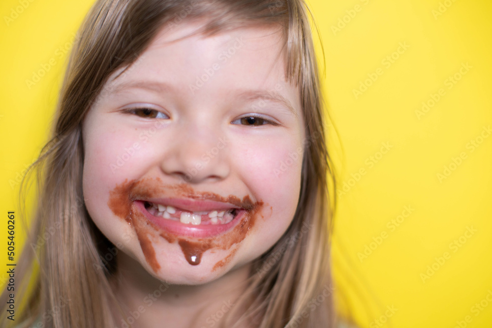 Laughing little girl eating chocolate dirty face Laughing little girl eating chocolate dirty face