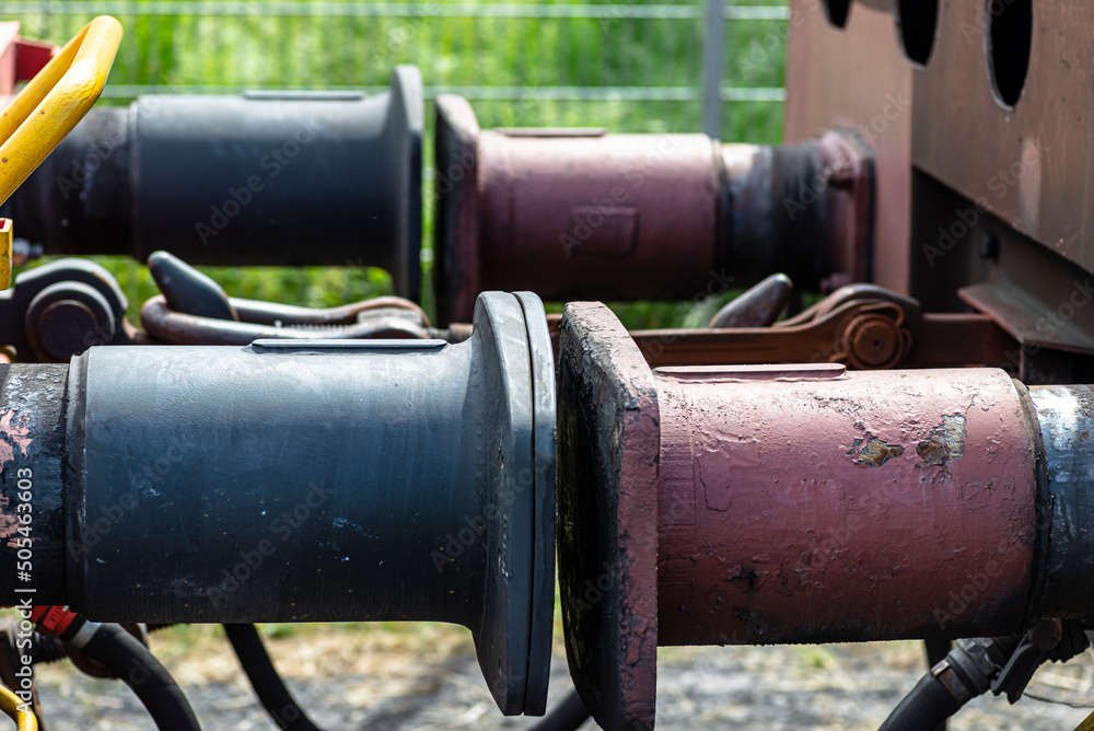 Chain coupler connecting freight wagons, large wagon buffers visible. Chain coupler connecting freight wagons, large wagon buffers visible.