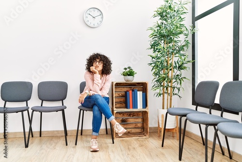 Young middle east woman desperate sitting on chair at waiting room photo