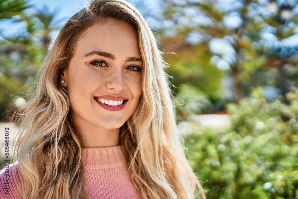 Young blonde woman smiling at the park Young blonde woman smiling at the park