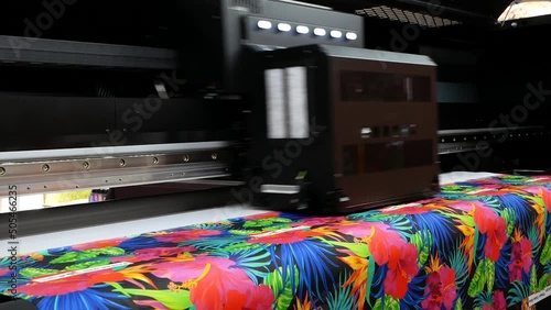 The plotter prints on a textile fabric. Production process in a manufacturing company. photo