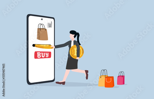Using bitcoin to buy goods, alternative convenient 
way for purchasing product or service with cryptocurrency concept. Woman inserting bitcoin token into money slot on mobile screen for shopping.