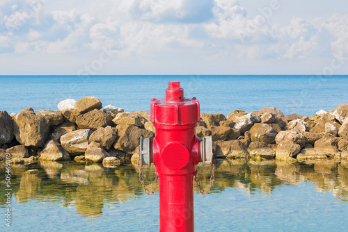 An improbable hydrant at the seaside - Plenty of water concept image photo