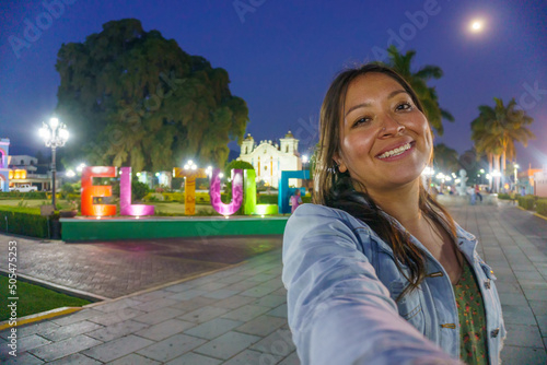 woman taking a selfie in el tule oaxaca mexico photo