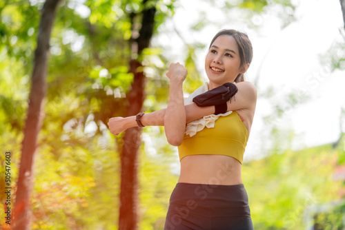 asian cheerful young adult Attractive and strong morning stretching before runin the park Sports concept. Healthy lifestyle Young fitness woman runner stretching before run on The park photo