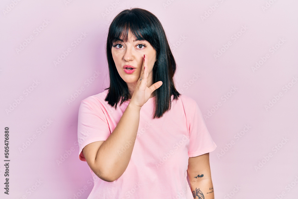 Young hispanic woman wearing casual clothes hand on mouth telling secret rumor, whispering malicious talk conversation