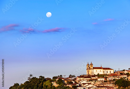 Colonial style church on the mountain with moonlight in the background in the historic city of Ouro Preto in Minas Gerais, Brazil